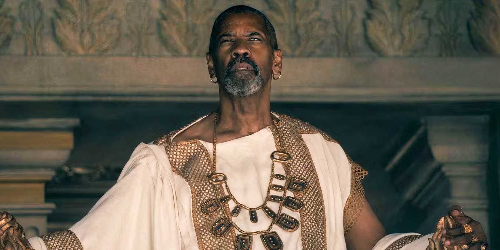 Denzel Washington as Macrinus wearing his white robe in Gladiator II