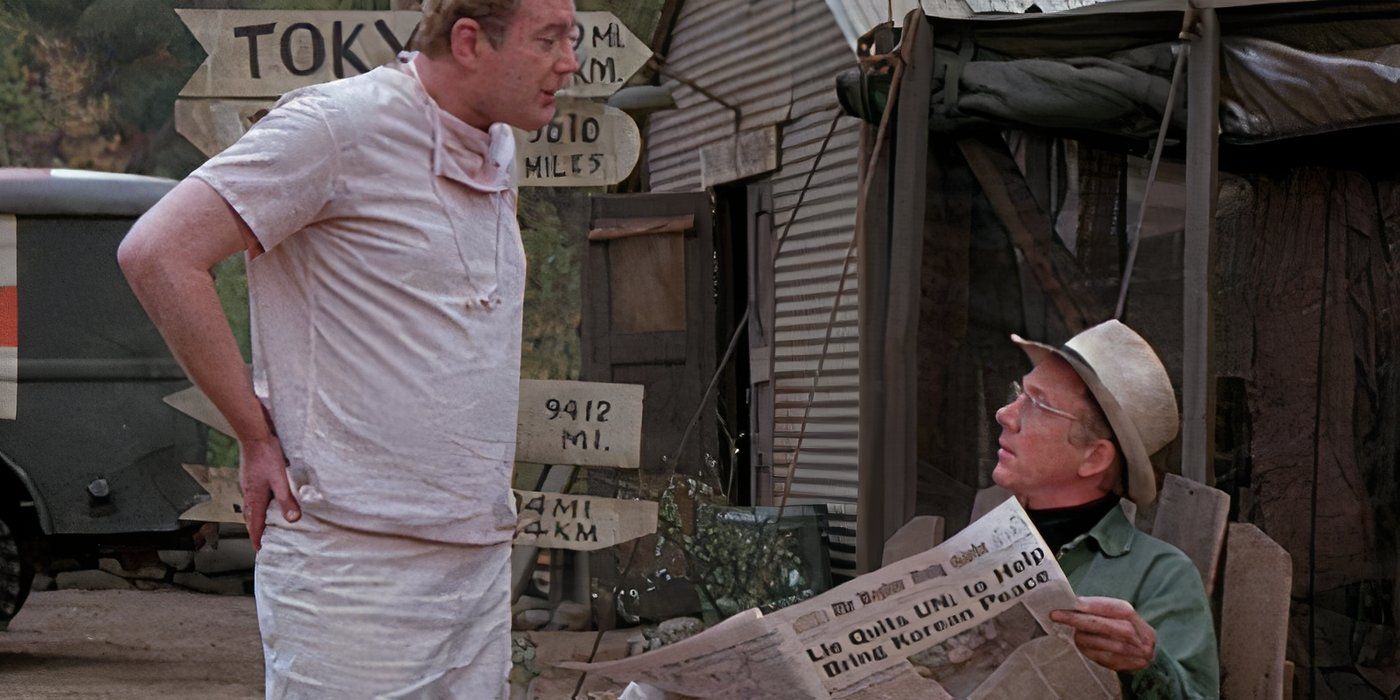 Charles talking to Father Mulcahy as he reads a paper in the MASH episode "Communication Breakdown."