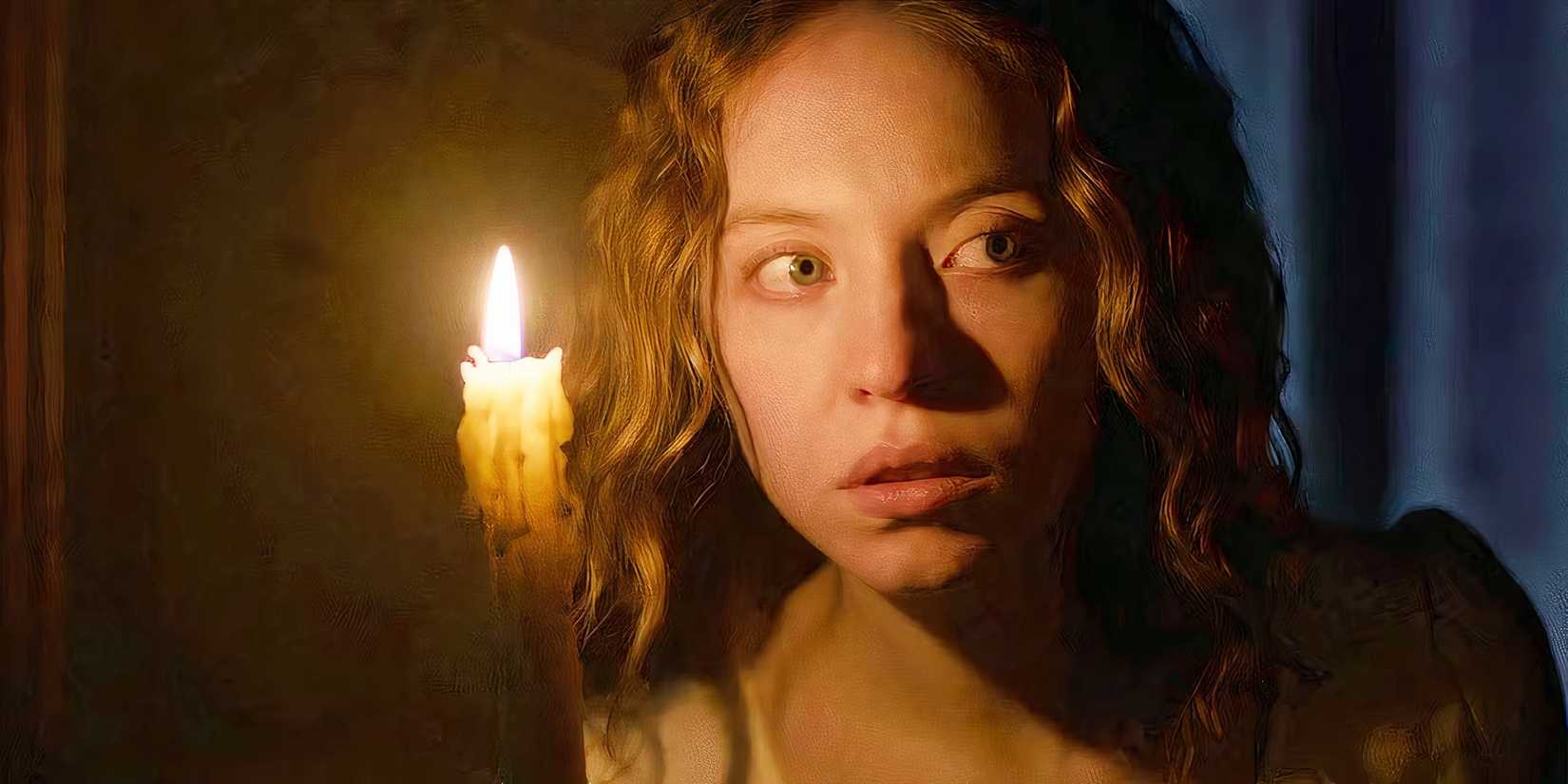 Sydney Sweeney's Cecilia holding a candle and looking worried in Immaculate
