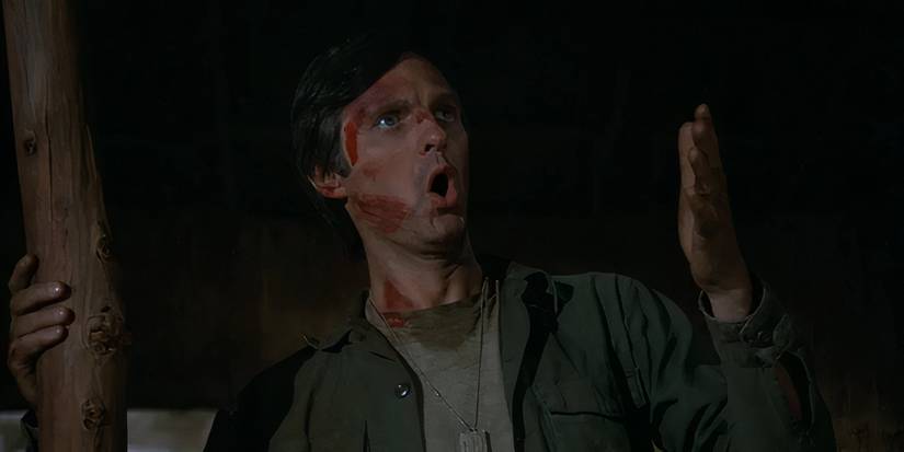Alan Alda as Hawkeye ranting and covered in blood in the MASH episode "Hawkeye."