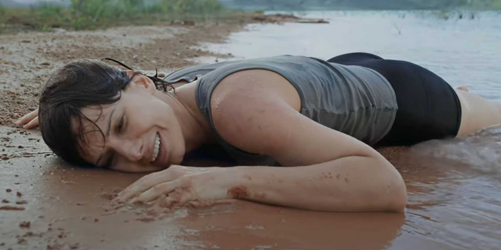 Sandra Bullock smiling as she washes up on shore as Dr. Ryan Stone in Gravity