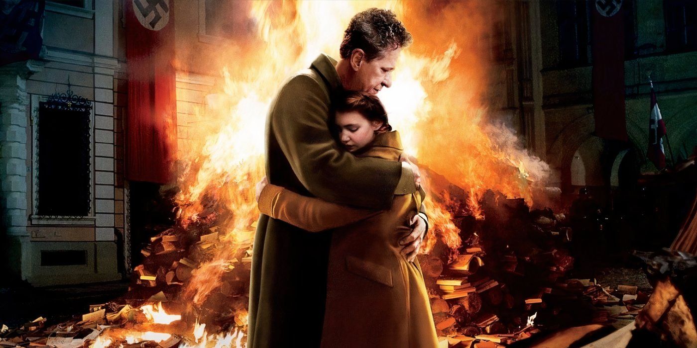 Liesel and Hans hugging in front of burning books