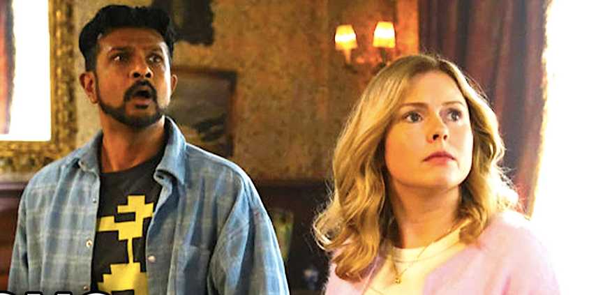 Utkarsh Ambudkar's Jay and Rose McIver's Sam stare at a wall in shock in Ghosts season 4