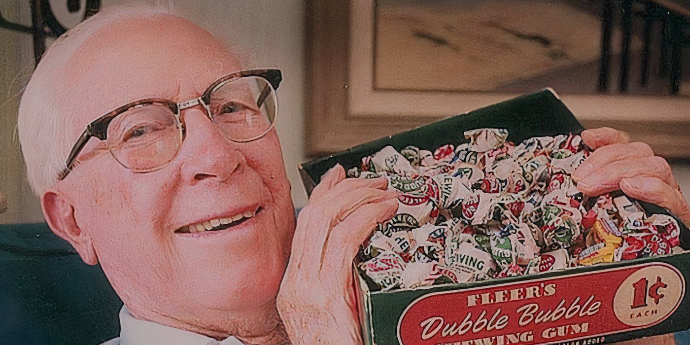 Walter Diemer, bubble gum inventor, holding up a box of gum