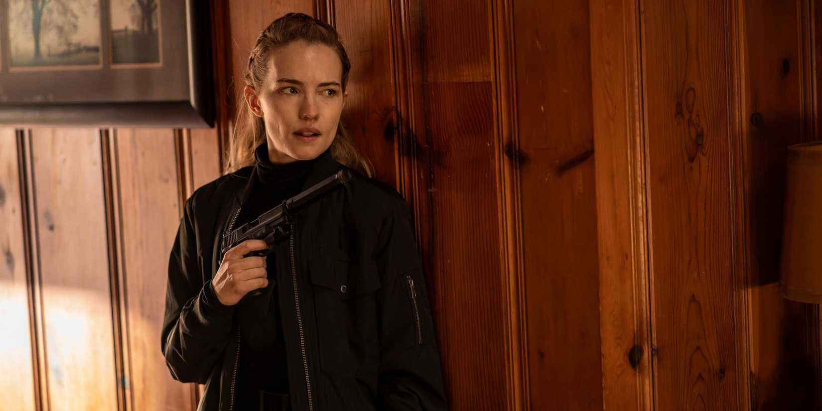 Willa Fitzgerald holding a pistol in Alarum