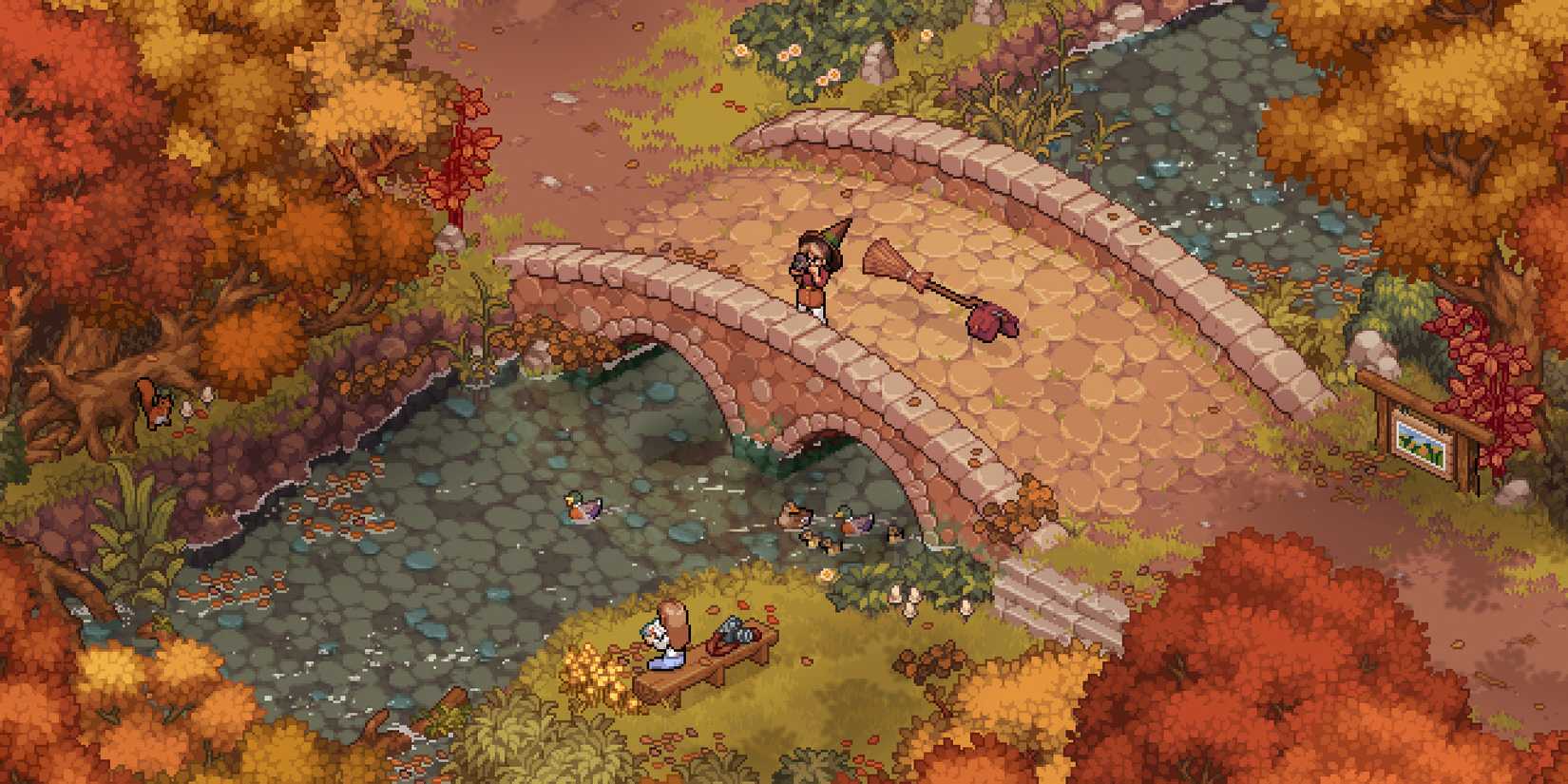 A witch standing on a bridge next to her broom. The bridge goes over a small steam surrounded by autumn trees. A woman sits on a bench with a book.