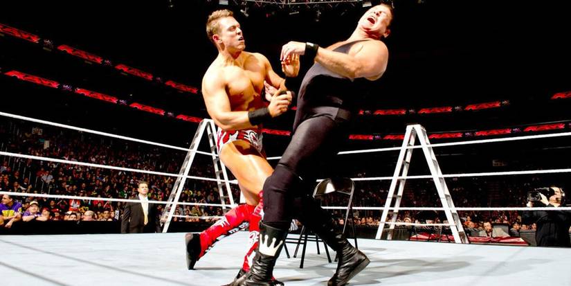 WWE Champion The Miz punches Jerry the King Lawler during their TLC Match on Monday Night Raw