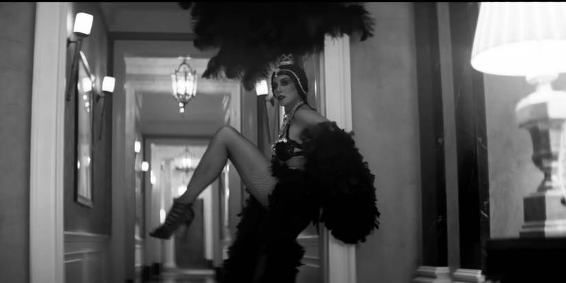 A woman in an elaborate 1920s flapper outfit in The Killers' "Your Side of Town" music video