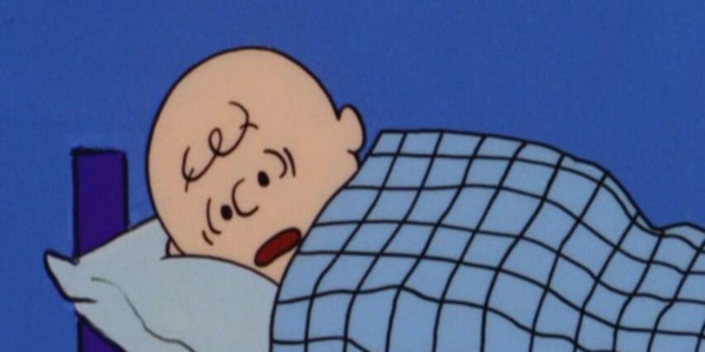 Charlie Brown awake in bed.