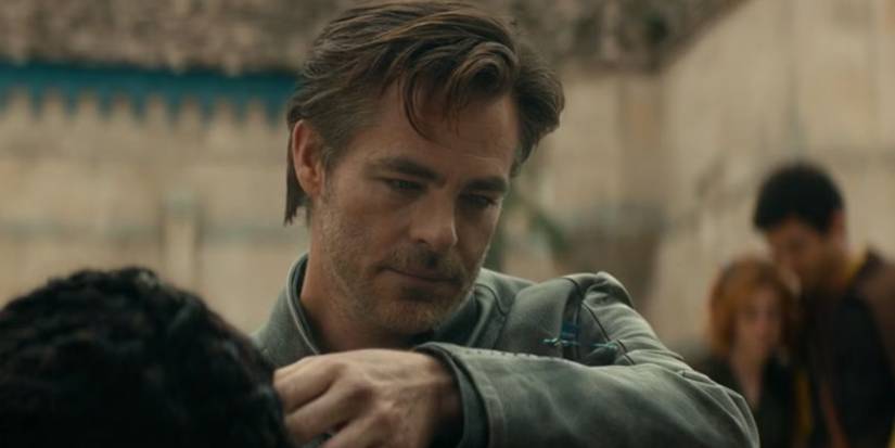 Chris Pine as Edgin looking at a dragonfly on his arm in Dungeons and Dragons: Honor Among Thieves