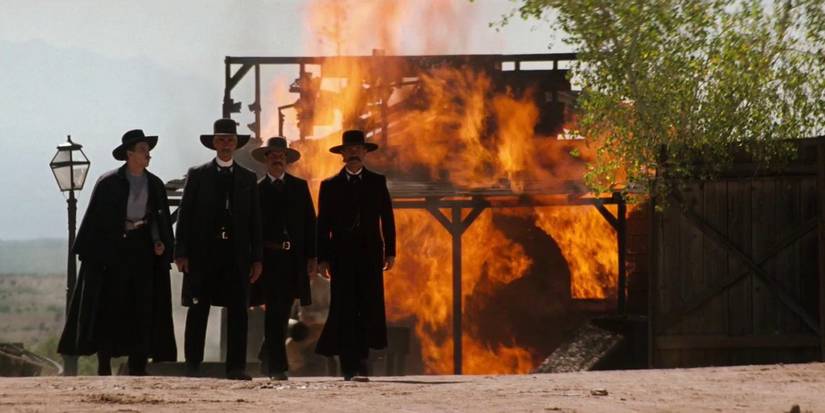 The Earps in front of a burning building in Tombstone