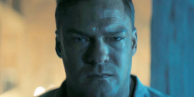 A close-up of Alan Ritchson as Reacher looking upset.
