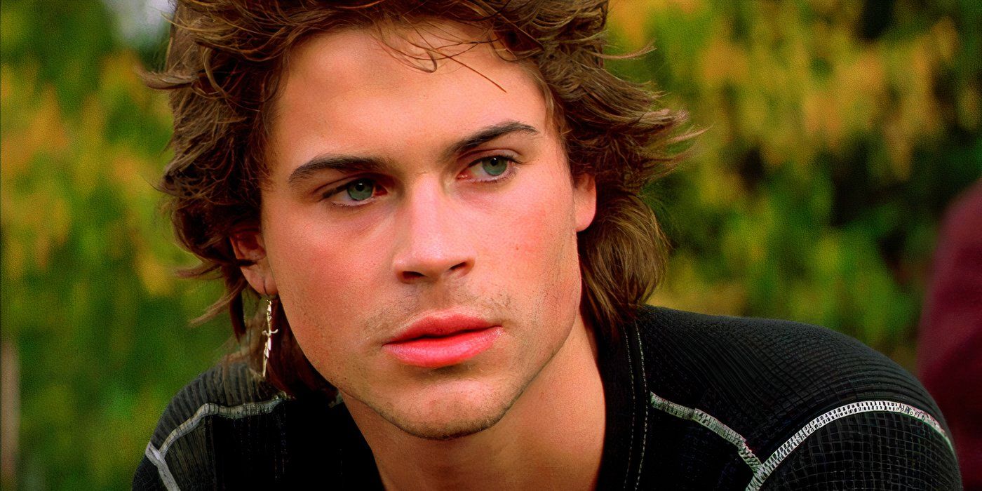 A closeup of Rob Lowe sitting on the lawn in St Elmo's Fire