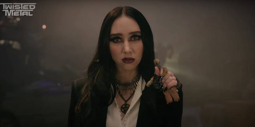 A goth character holds a voodoo doll while looking angry in Twisted Metal season 2