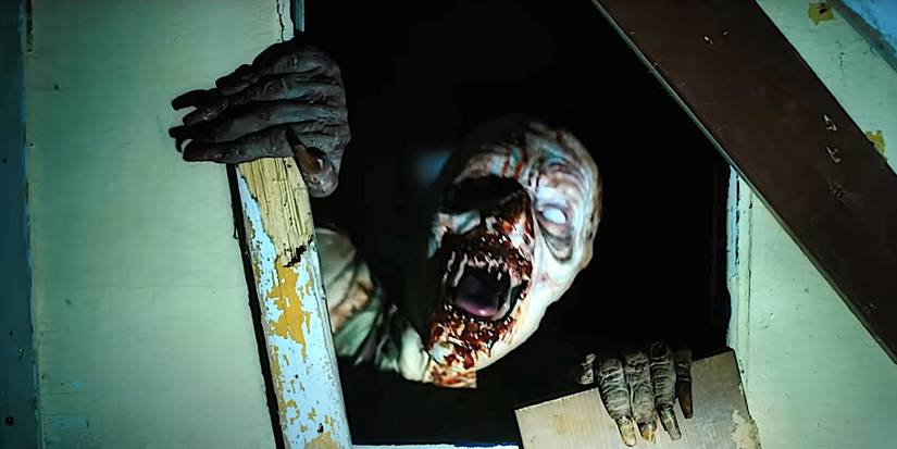 A wendigo screams at the camera through a broken door in Until Dawn 2025 trailer