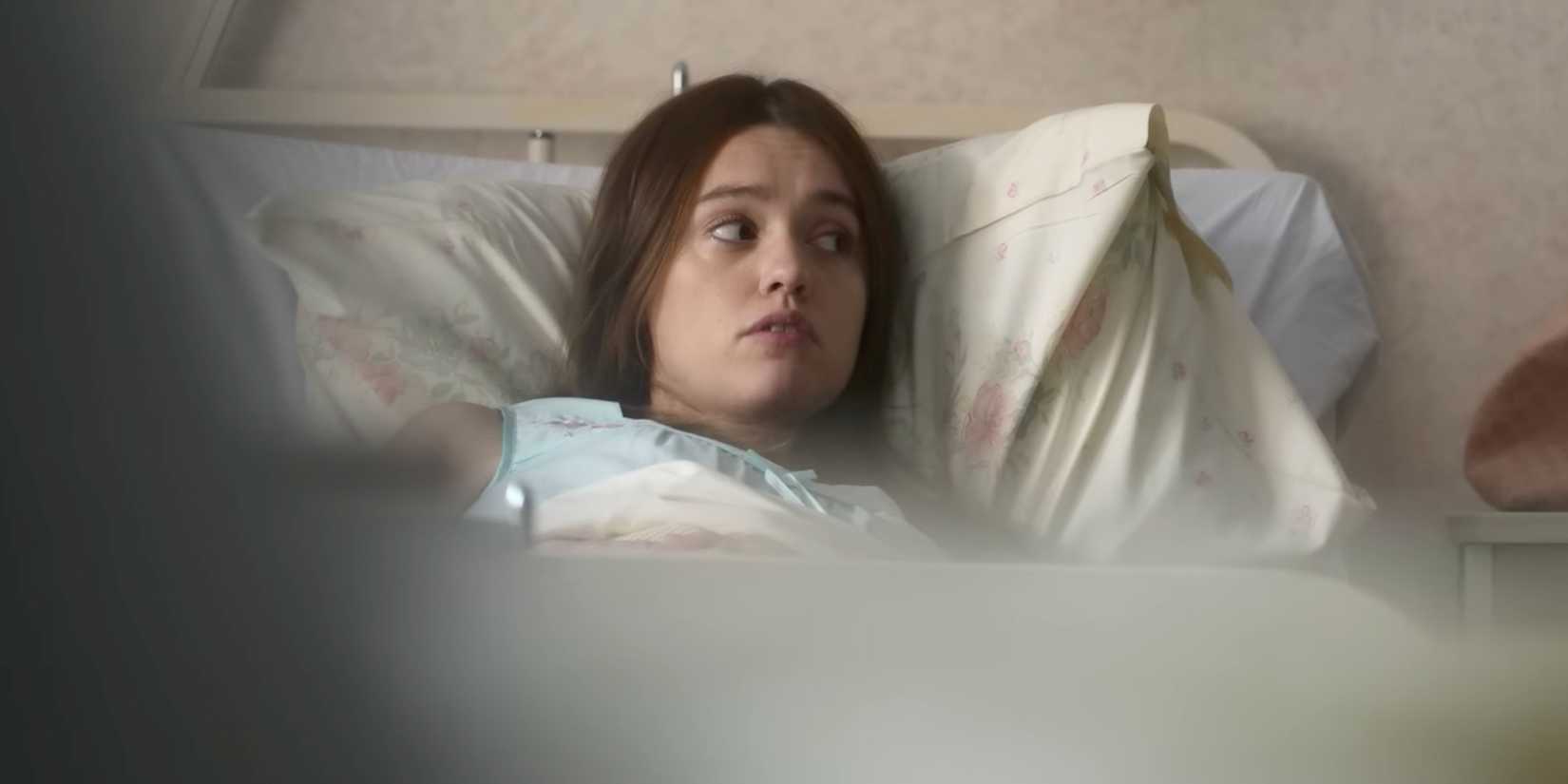Aimee Lou Wood as Tracey Taylor sitting on a hospital bed in Toxic Town
