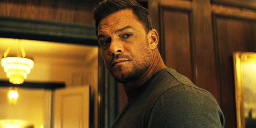 Alan Ritchson as Jack Reacher, looking back at someone, in Reacher season 2, episode 1