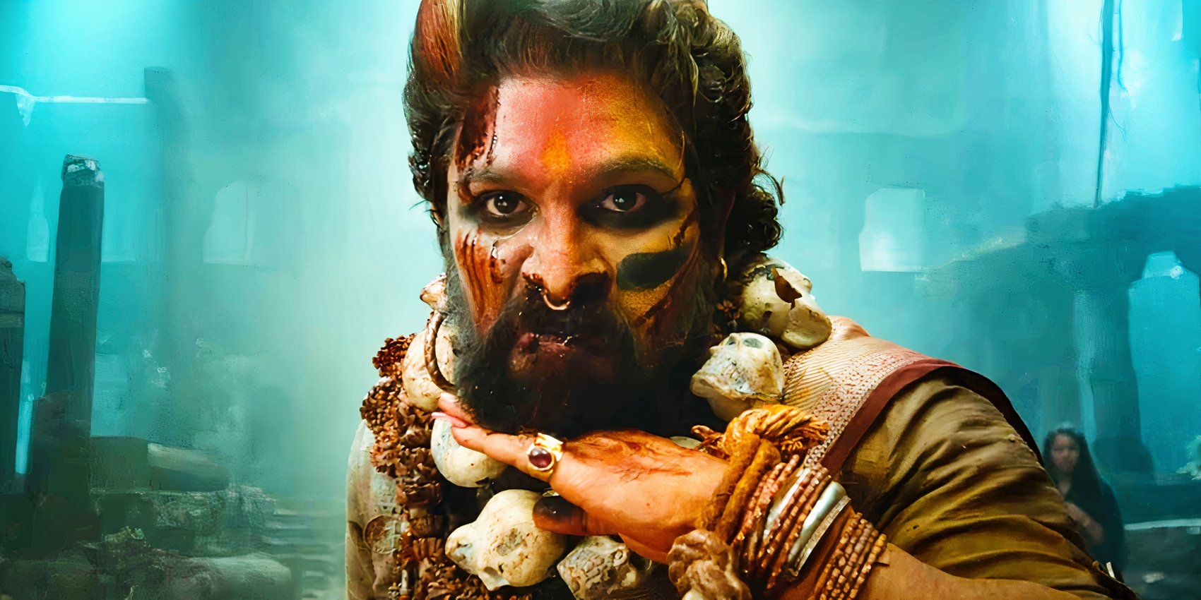 Allu Arjun with his face painted and sliding his hand under his chin in Pushpa 2 The Rule