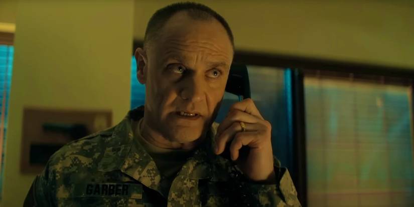 Andreas Apergis as Garber talking on phone in Reacher season 3 episode 4