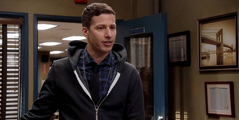 Andy Samberg as Jake Peraltam standing in Holt's office in Brooklyn Nine-Nine