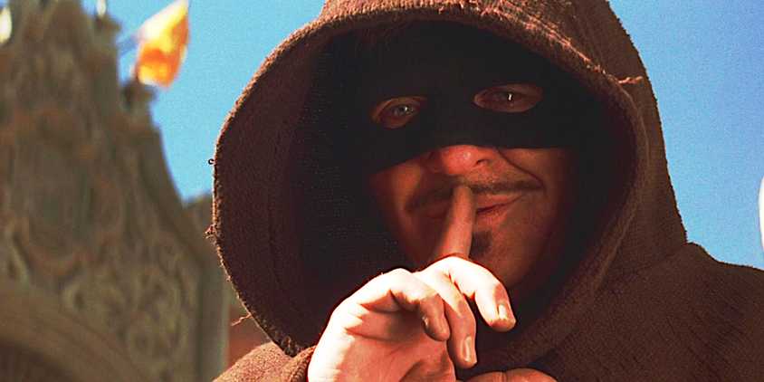 Masked Anthony Hopkins tells someone to shush in a scene from The Mask of Zorro