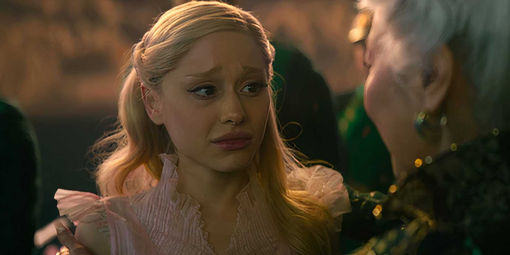 Ariana Grande as Glinda looking heartbroken in Wicked