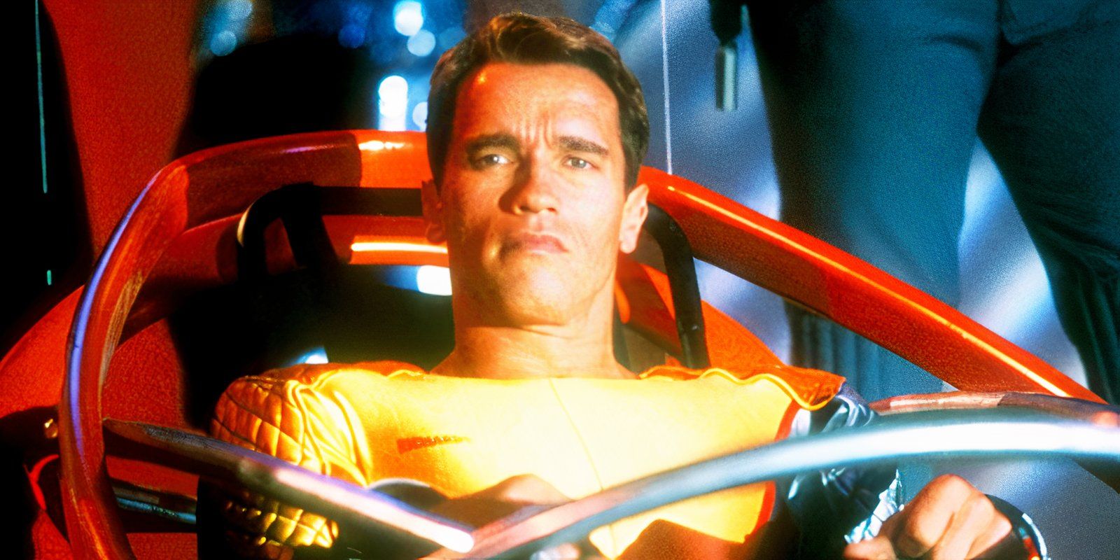 Arnold Schwarzenegger sitting in a sci-fi vehicle as Ben Richards in The Running Man