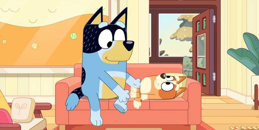 Bandit smiling at Bingo who's lying on a couch in a Bluey minisode