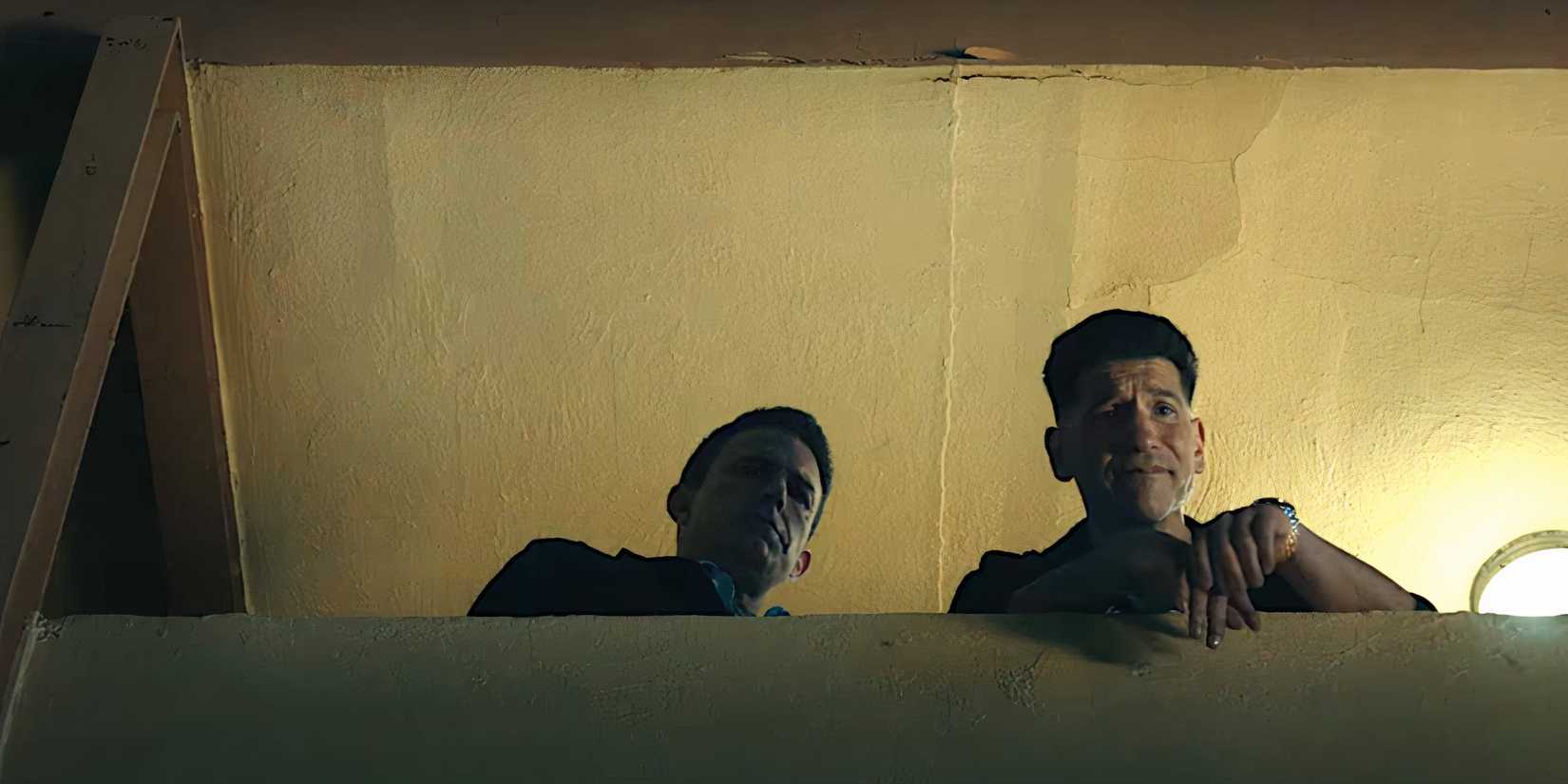 Ben Affleck and Jon Bernthal look down from a concrete balcony in a scene from The Accountant 2