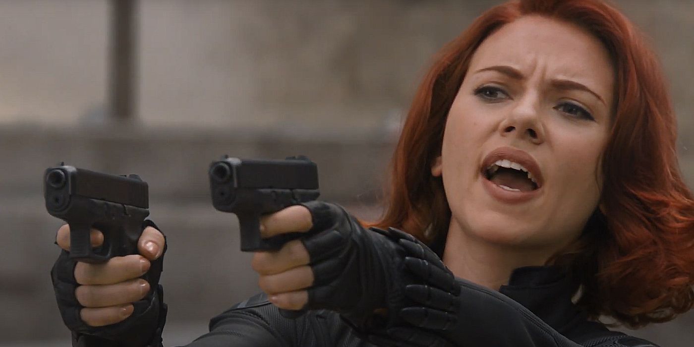 black widow holding two guns in the avengers