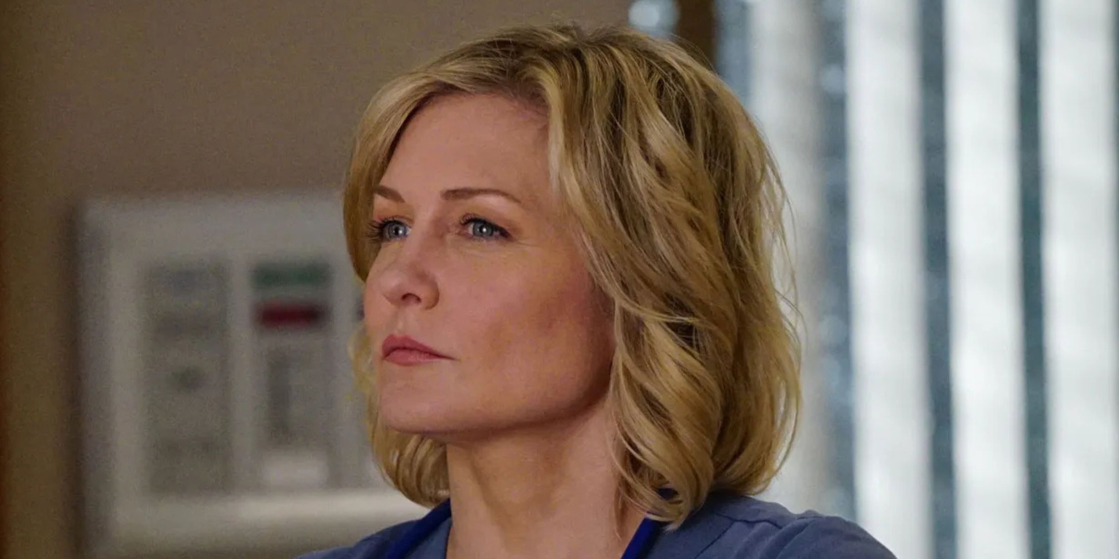 Blue Bloods Amy Carlson as Linda Reagan standing in the hospital with head and shoulders visible