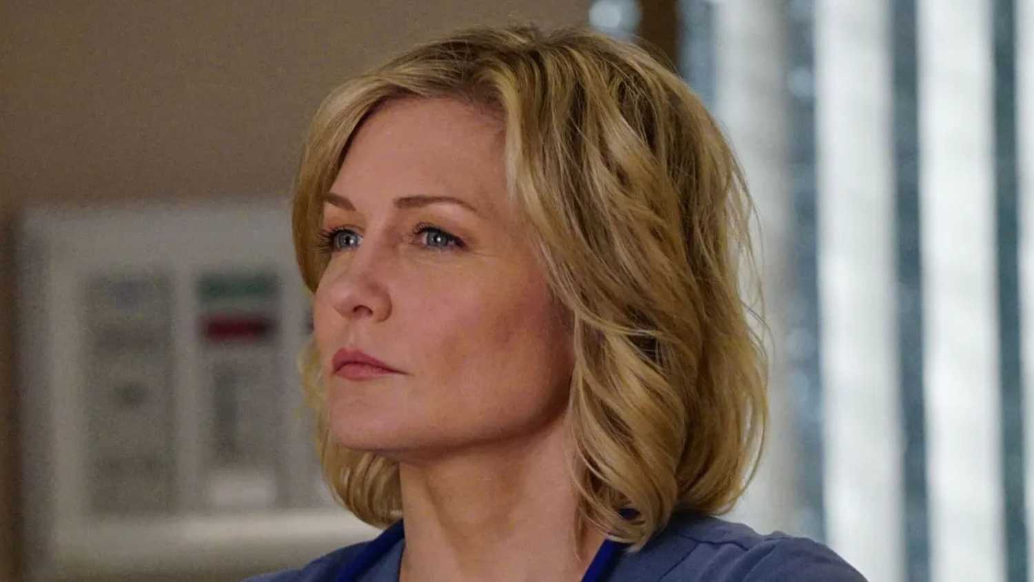 Blue Bloods Amy Carlson as Linda Reagan standing in the hospital with head and shoulders visible