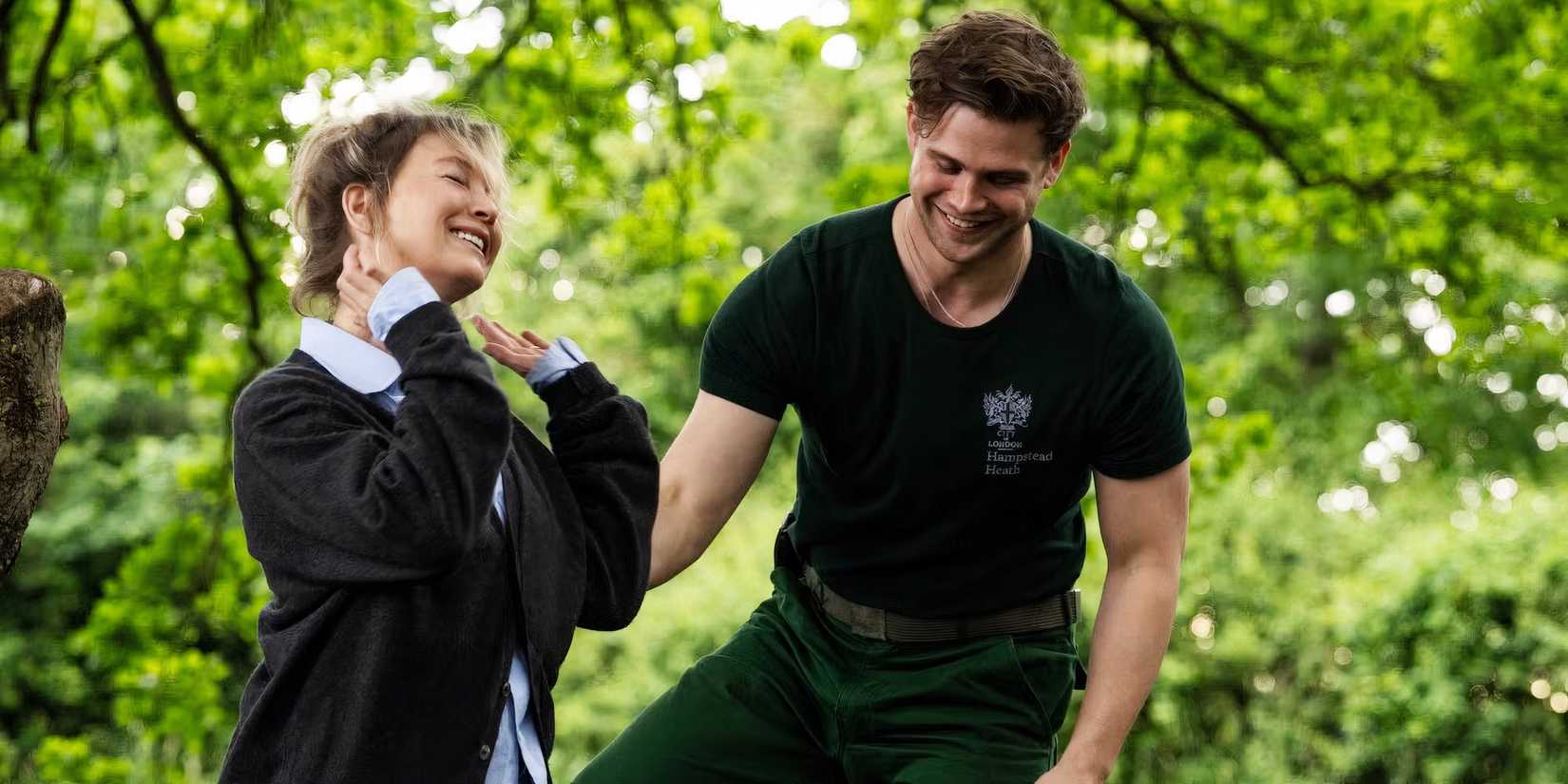 Renée Zellweger as Bridget and Leo Woodall as Roxster smiling while walking in Bridget Jones: Mad About the Boy
