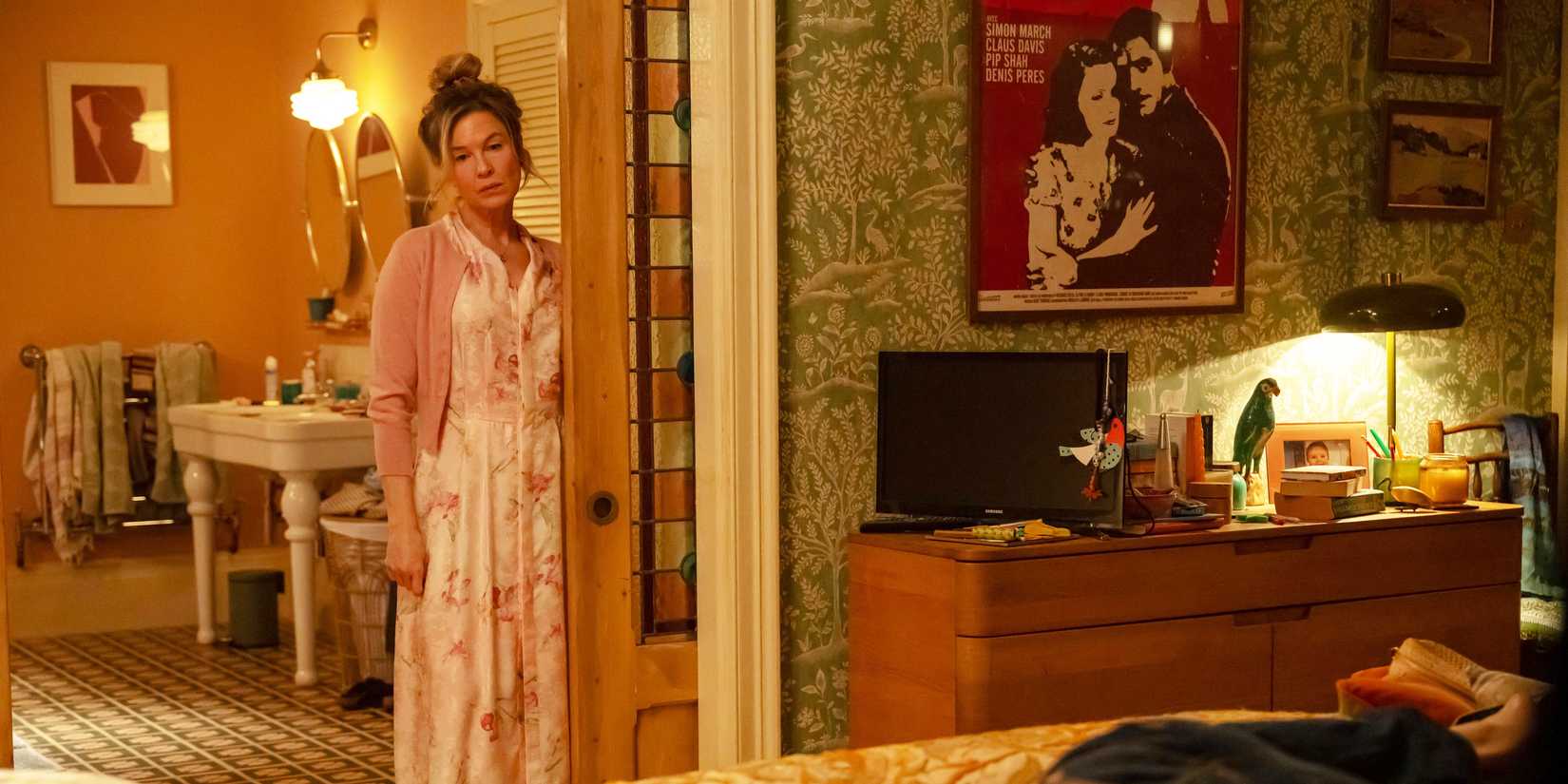 Bridget Jones Mad About the Boy Bridget looking at Roxster on her bed