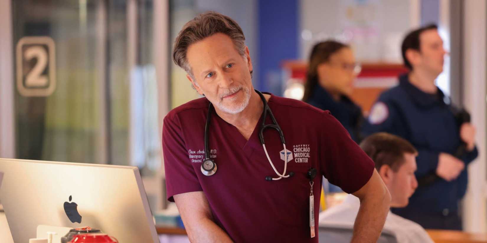 Chicago Med Archer leaning on a desk in an inebriated state