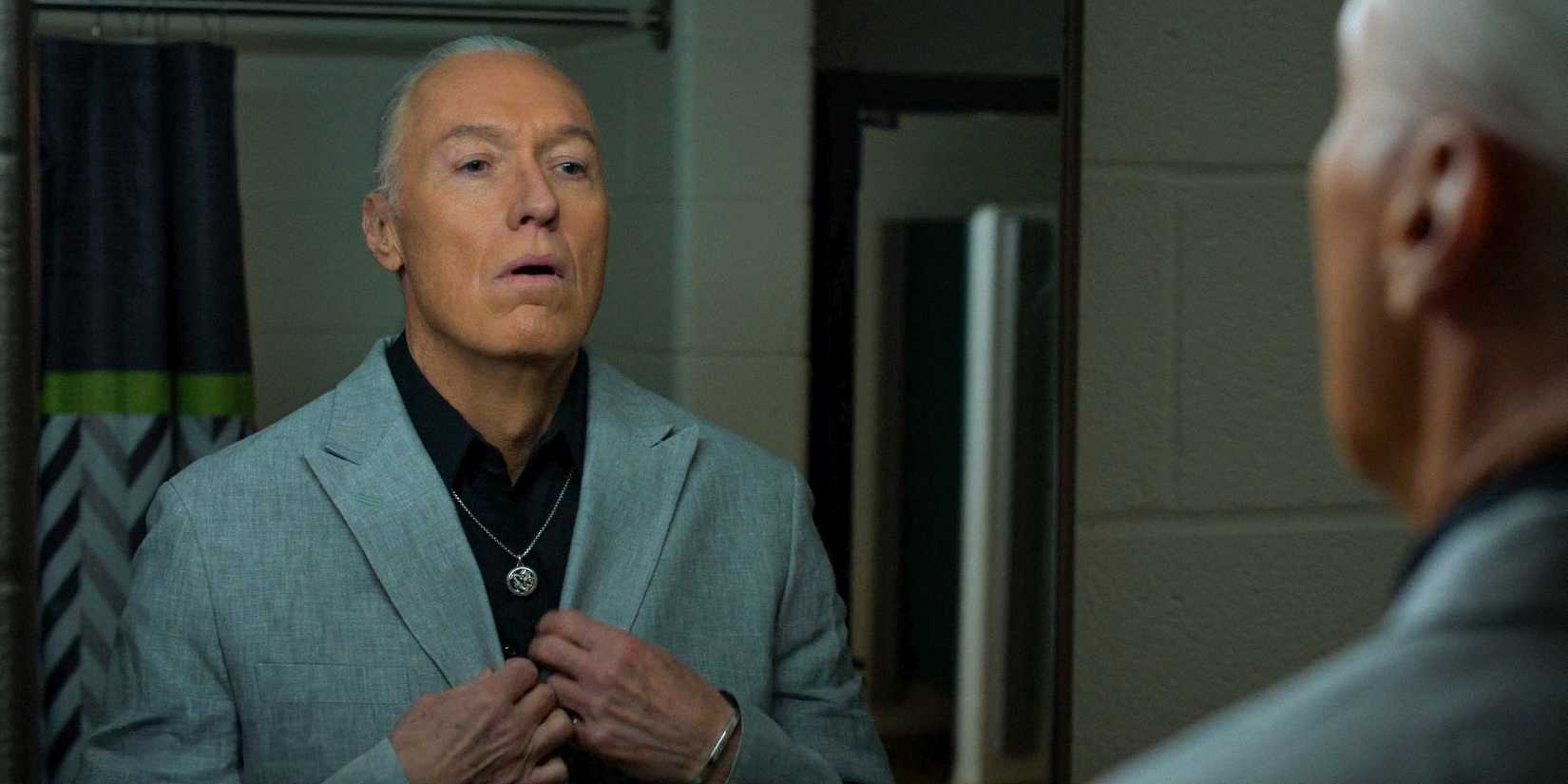 Terry Silver (Thomas Ian Griffith) looking at himself in the mirror in Cobra Kai Season 6 Ep 13