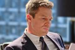 Stephen Amell looking aggrieved in his office in Suits LA