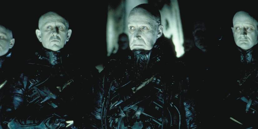 The Strangers standing in the shadows in Dark City.