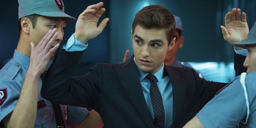 Dave Franco with his hands up while being searched in Now You See Me