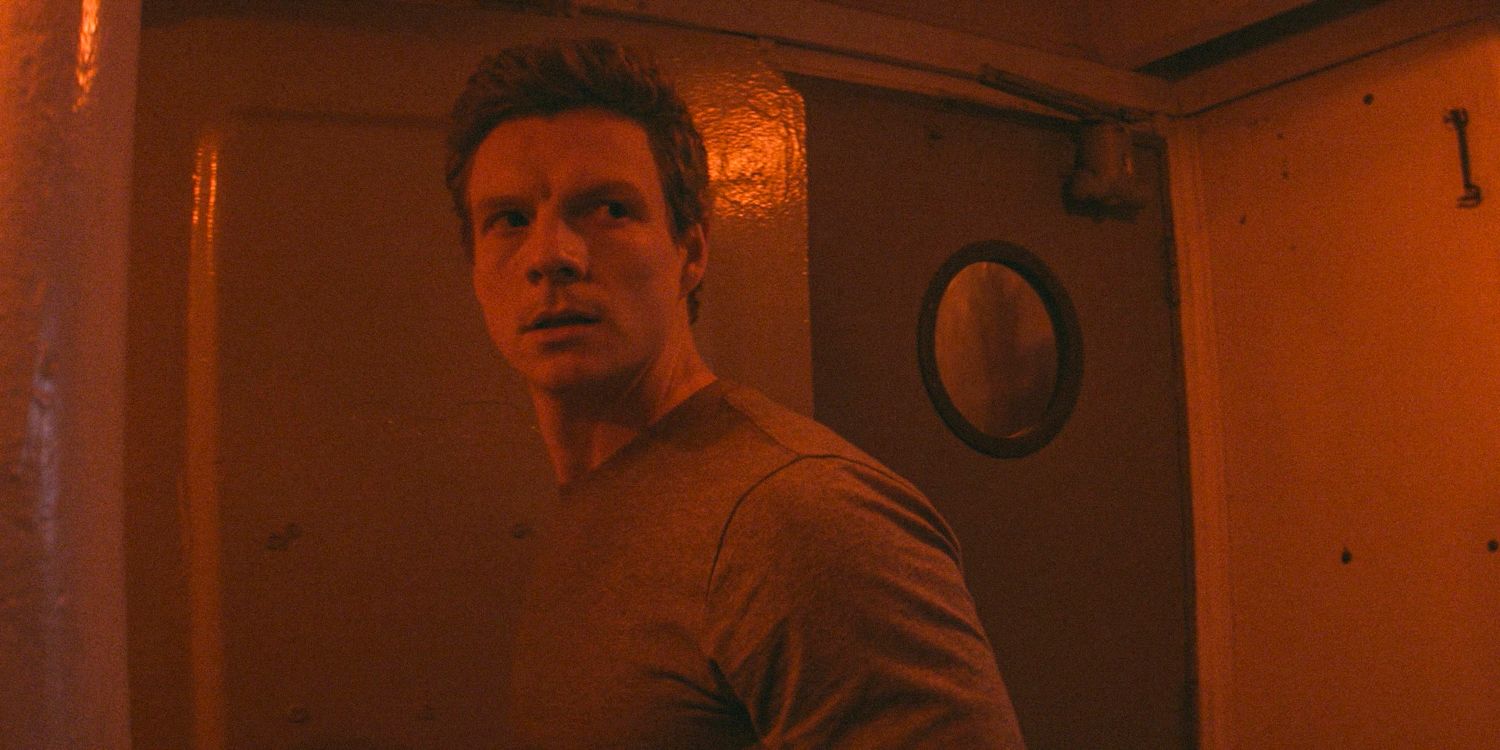 Patrick Gibson as Dexer illuminated by red in a ship in Dexter Original Sin