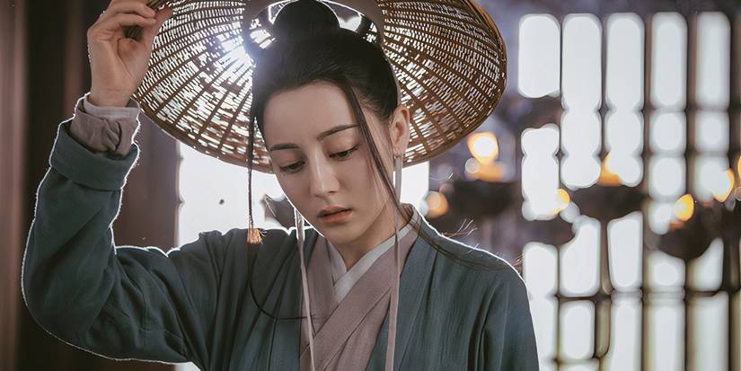 Dilraba Dilmurat putting on a hat in The Long Ballad