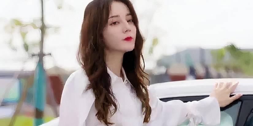 Dilraba Dilmurat with her hand on a car in Love Designer