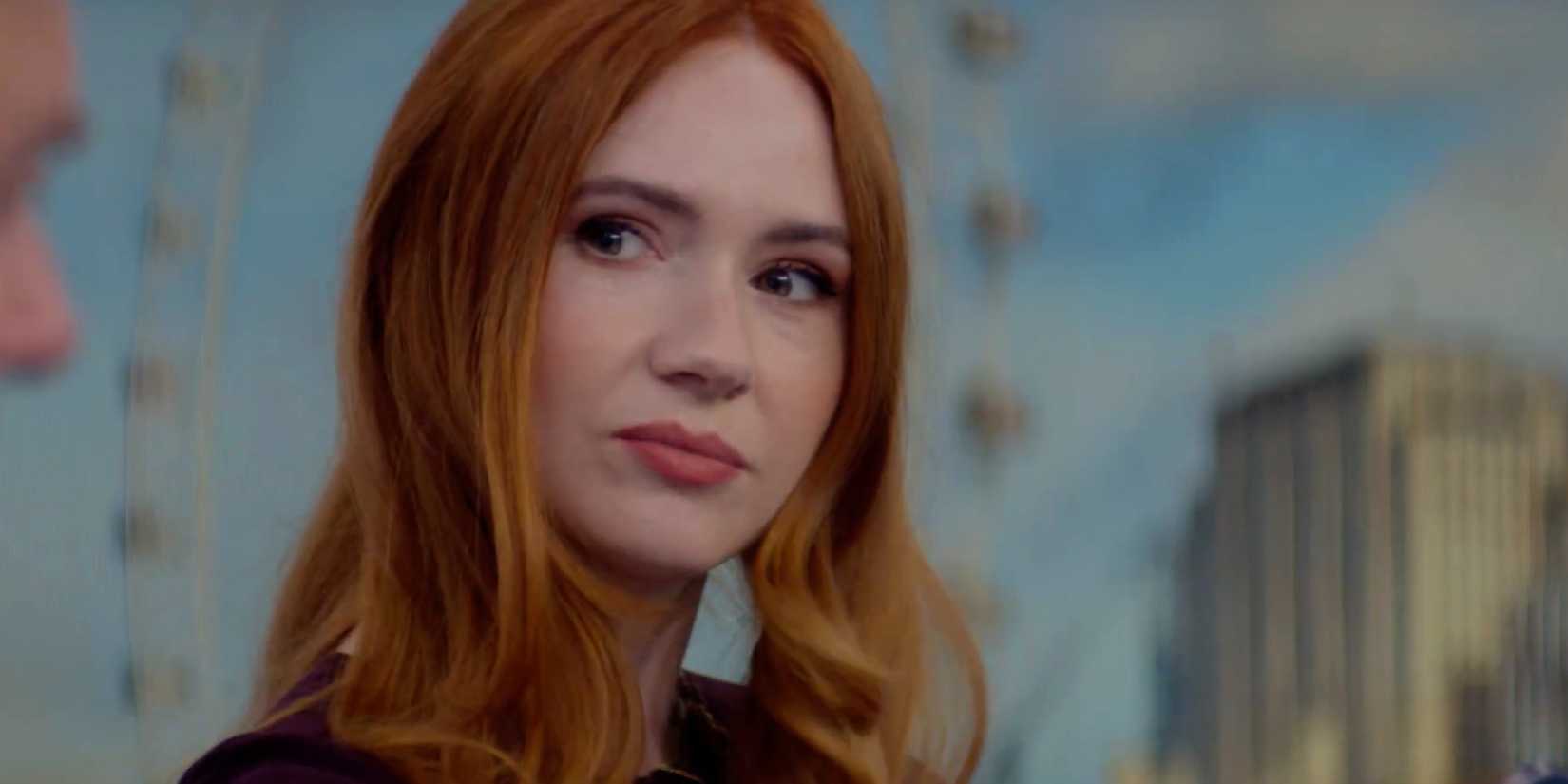Douglas is Cancelled Karen Gillan looking to her side while working in front of a backdrop at work