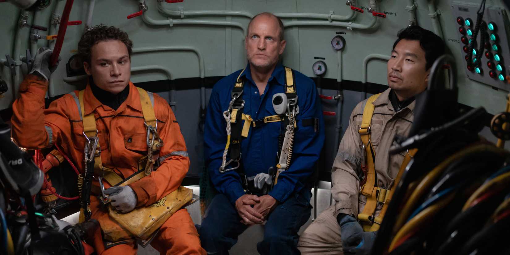 Finn Cole, Woody Harrelson, and Simu Liu sit together in their diving gear in Last Breath