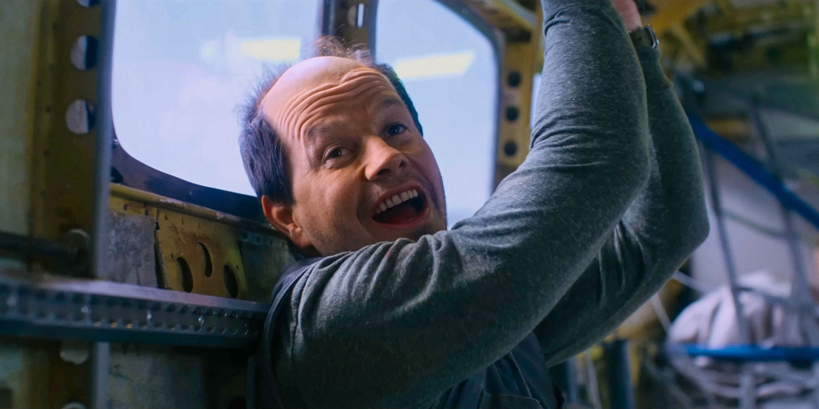 Daryl (Mark Wahlberg) with a mocking laugh, hands tied in Flight Risk