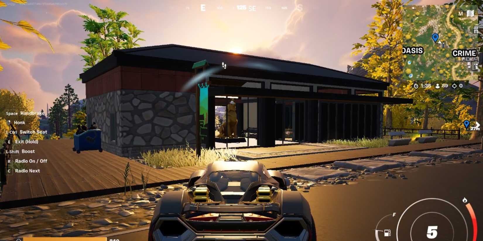 Fortnite Chapter 6 Season 2 Player In car in Predator Peak Overlook looking at a building.