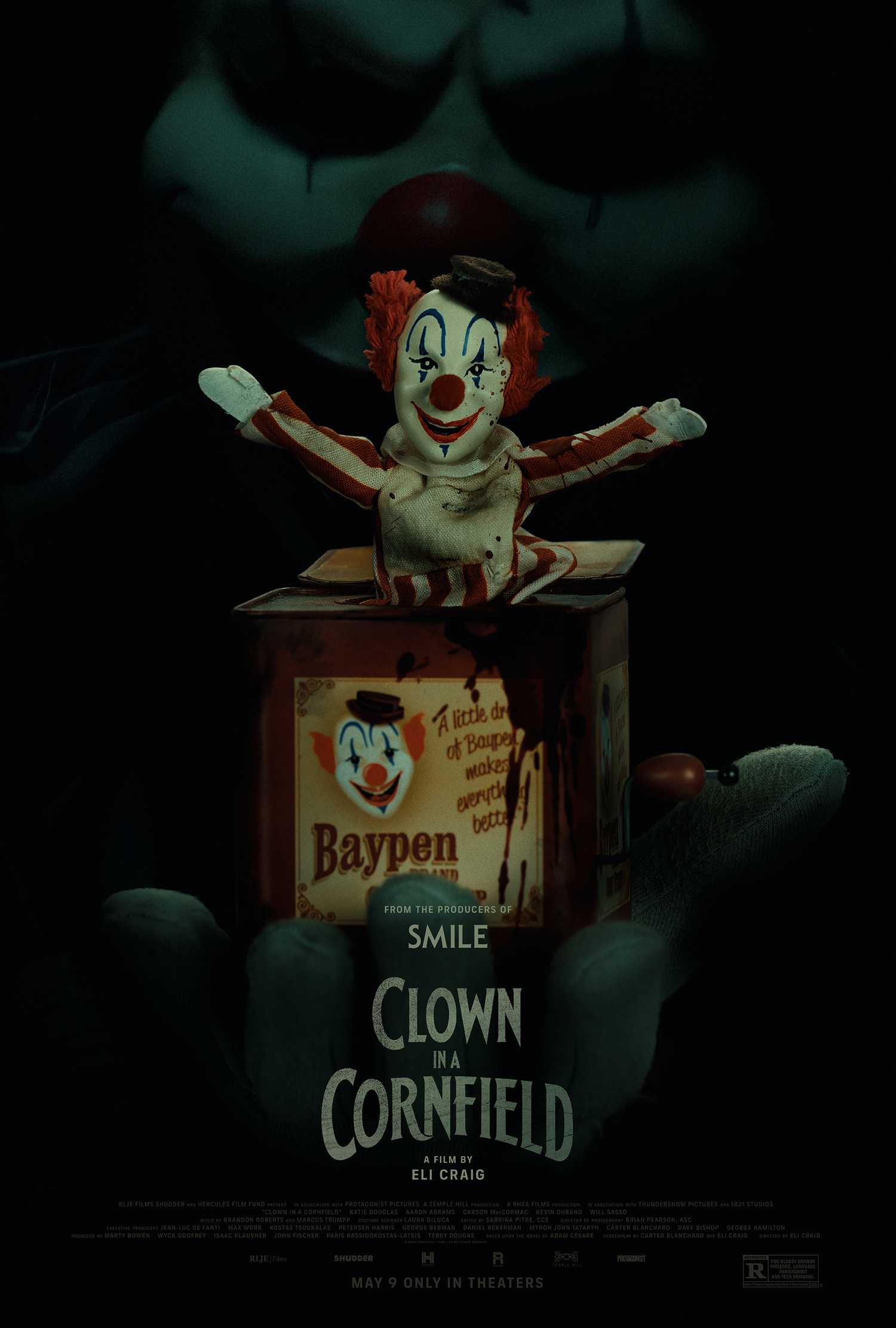 Frendo lurking behind a clown jack in the box on the teaser poster for Clown in a Cornfield