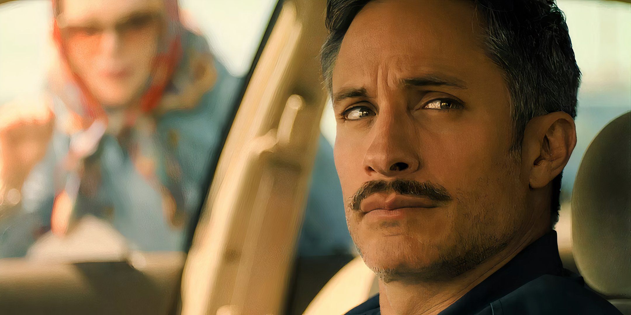 Gael García Bernal as Diego sitting in his car with Nicole Kidman's Nancy knocking on the window in Holland