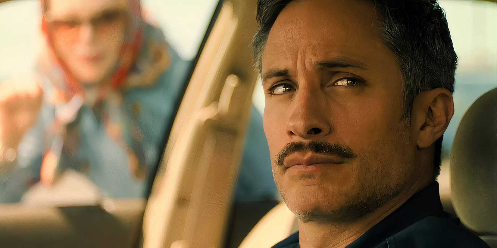 Gael García Bernal as Diego sitting in his car with Nicole Kidman's Nancy knocking on the window in Holland