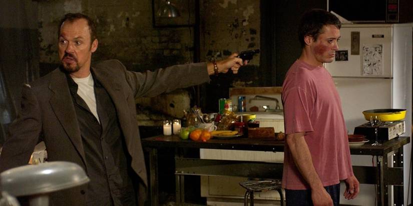 Michael Keaton aiming a weapon at Robert Downey Jr. In Game 6
